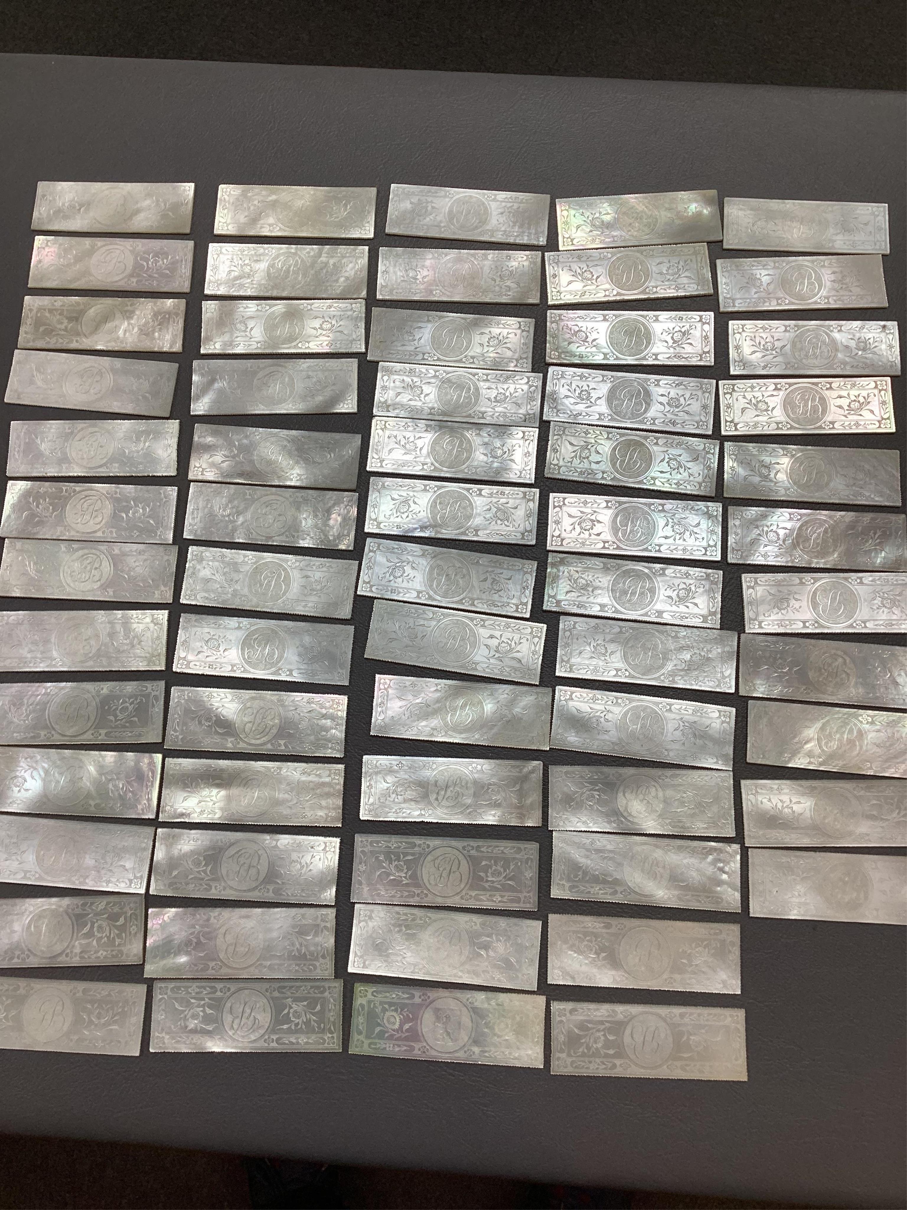 Two Chinese gilt decorated black lacquer games boxes, containing numerous mother-of-pearl counters, 19th century